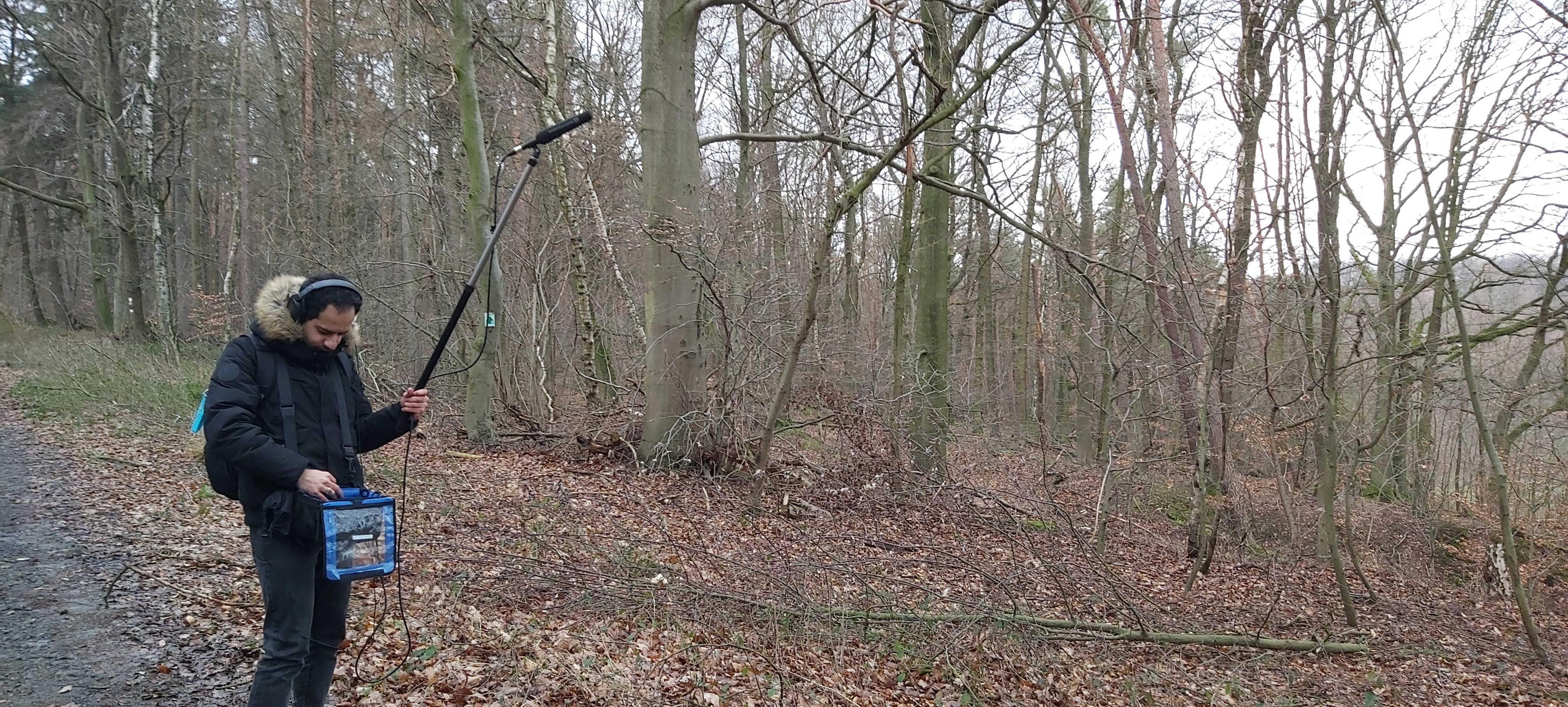 Mostafa recording field audio in the forest for Fl&uuml;sterwald